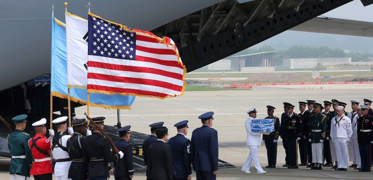 A U.N. honor guard carries a casket containing remains believed to be from American servicemen killed during the 1950-53 Korean War after arriving from North Korea, at Osan Air Base in Pyeongtaek, South Korea, on July 27, 2018. (Photo: AP)