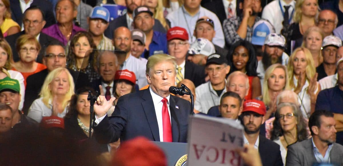 President Donald Trump touts "promises kept" A support tries to capture a photo/video of President Donald Trump President Donald Trump jokes with the crowd President Donald Trump touts record low unemployment for minorities during a rally in Tampa, Florida on Tuesday, July 31, 2018. (Photo: Laura Baris/People's Pundit Daily)