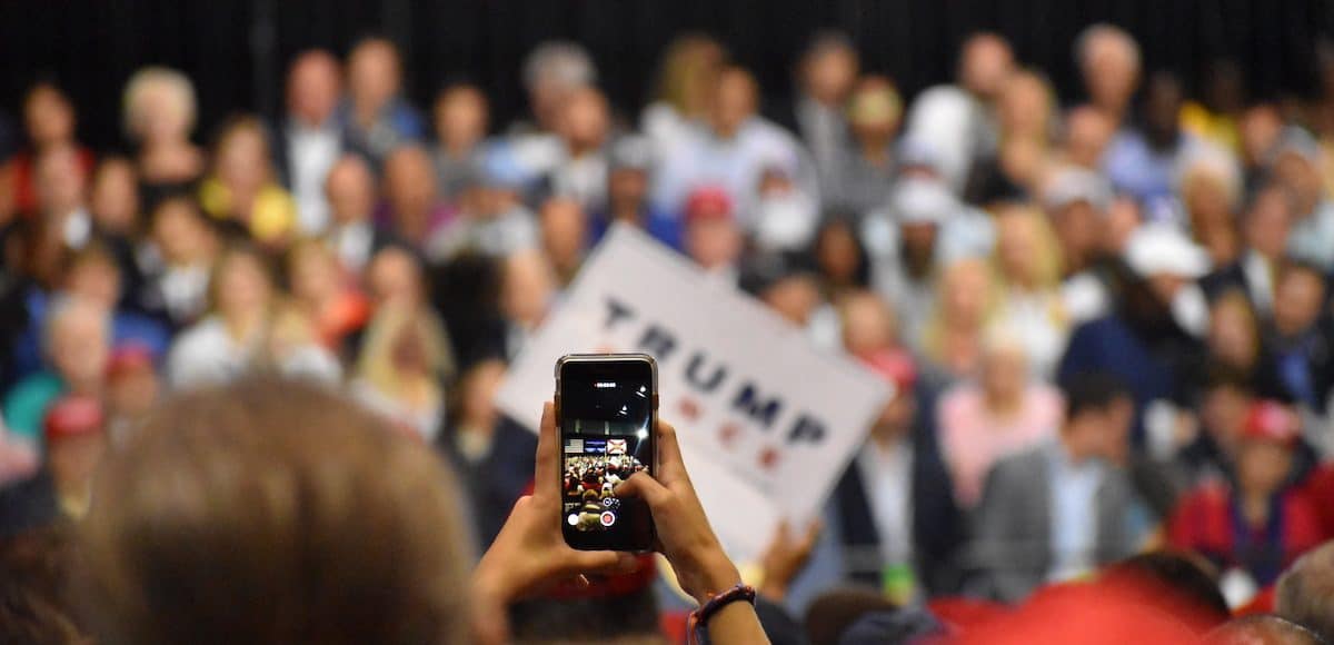 A support tries to capture a photo/video of President Donald Trump President Donald Trump jokes with the crowd President Donald Trump touts record low unemployment for minorities during a rally in Tampa, Florida on Tuesday, July 31, 2018. (Photo: Laura Baris/People's Pundit Daily)