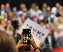 A support tries to capture a photo/video of President Donald Trump President Donald Trump jokes with the crowd President Donald Trump touts record low unemployment for minorities during a rally in Tampa, Florida on Tuesday, July 31, 2018. (Photo: Laura Baris/People's Pundit Daily)