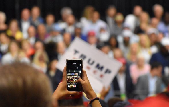 A support tries to capture a photo/video of President Donald Trump President Donald Trump jokes with the crowd President Donald Trump touts record low unemployment for minorities during a rally in Tampa, Florida on Tuesday, July 31, 2018. (Photo: Laura Baris/People's Pundit Daily)