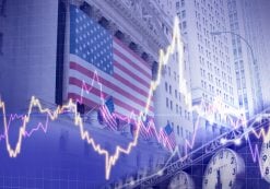 Markets concept depicting the American flag draped over the New York Stock Exchange (NYSE) at Wall Street. (Photo: AdobeStock)