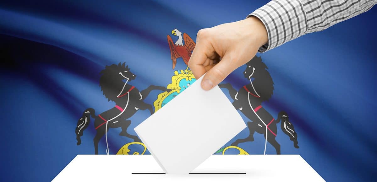 Voting, elections and state polls concept: Ballot box with state flag in the background - Pennsylvania. (Photo: AdobeStock)