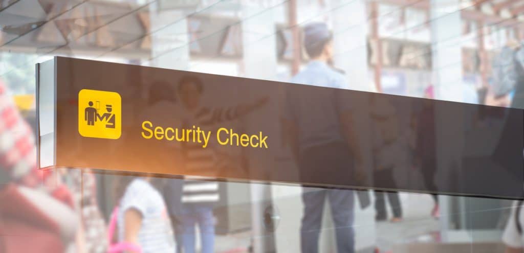 Double exposure of security check airport sign. Airport security check at gates with metal detector and scanner. (Photo: AdobeStock)