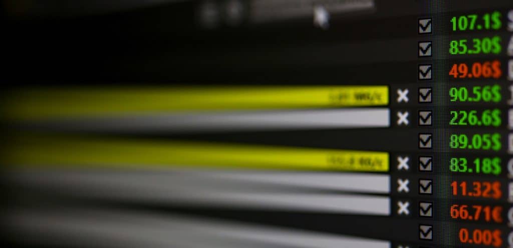 Stock quotes and trading stats in U.S. dollars shown closeup on a display monitor. (Photo: AdobeStock)