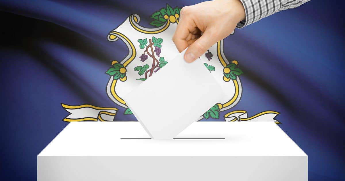 Voting, elections and state polls concept: Ballot box with state flag in the background - Connecticut. (Photo: AdobeStock)