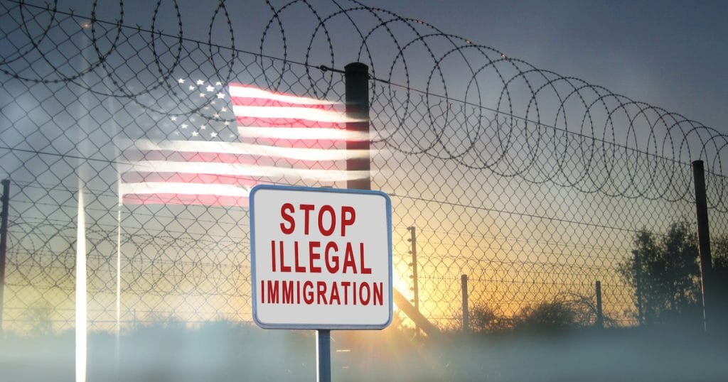 A graphic concept of barbed-wire, chain-linked fencing at the U.S. southern border with a sign reading, "Stop Illegal Immigration." (Photo: AdobeStock/Thea Photography)