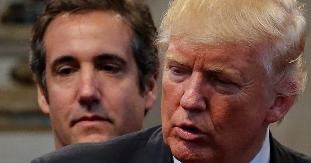 Former attorney Michael Cohen stands behind Donald Trump. (Photo: Screenshot Google News)