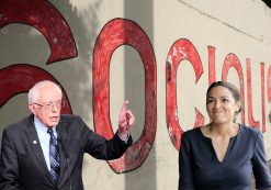 Un mur de propagande, or a propaganda wall, promoting socialism behind Senator Bernie Sanders, D-I, Vt., left, and Alexandria Ocasio-Cortez, D-N.Y., right.