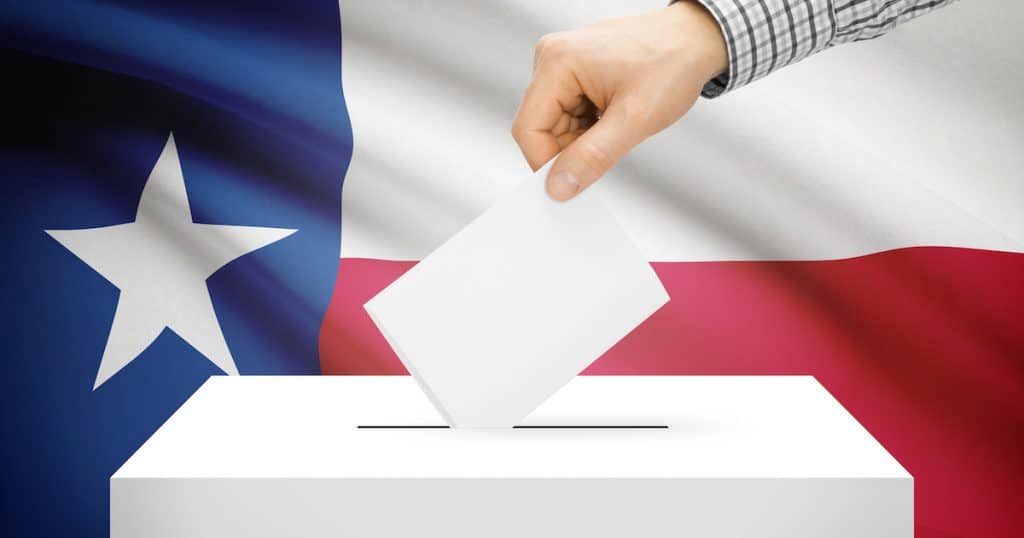 Voting, elections and state polls concept: Ballot box with state flag in the background - Texas. (Photo: AdobeStock)