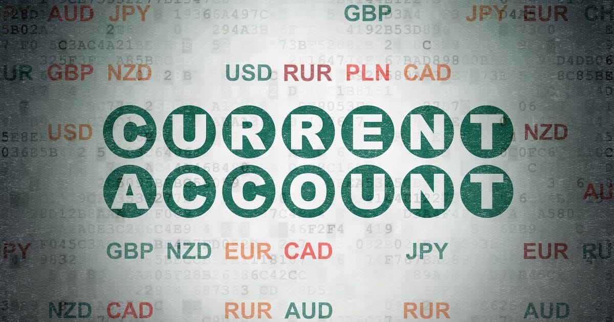 Current account balance concept: painted green text Current Account on digital data paper background with currency. (Photo: AdobeStock)