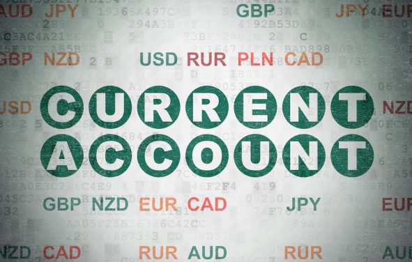 Current account balance concept: painted green text Current Account on digital data paper background with currency. (Photo: AdobeStock)