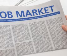 Man reading newspaper with the headline Job Market. (Photo: AdobeStock)