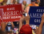 Supporters of President Donald Trump hold up Make America Great American and Keep America Great signs A supporter of Donald Trump dons a T-shirt with a new twist on an old joke targeting Hillary Clinton during a rally in Tampa, Florida on Tuesday, July 31, 2018. (Photo: Laura Baris/People's Pundit Daily)