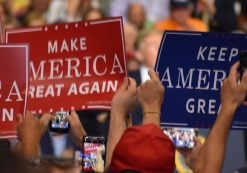 Supporters of President Donald Trump hold up Make America Great American and Keep America Great signs A supporter of Donald Trump dons a T-shirt with a new twist on an old joke targeting Hillary Clinton during a rally in Tampa, Florida on Tuesday, July 31, 2018. (Photo: Laura Baris/People's Pundit Daily)