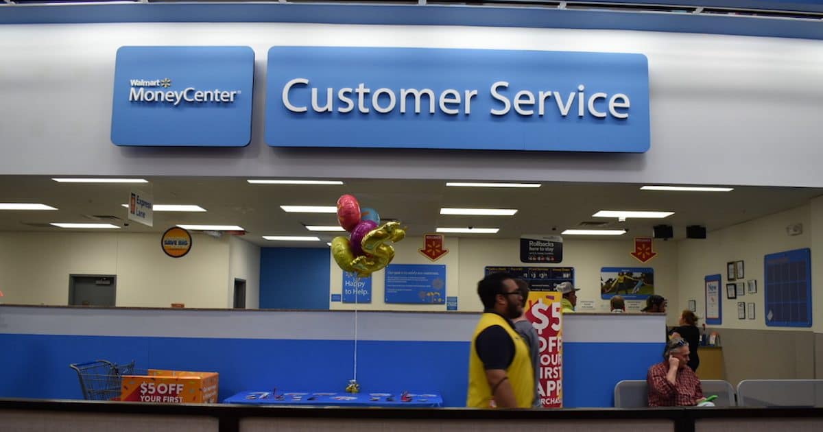 A Walmart employee who serves as a "customer host," walks in front of the customer service desk at a Walmart super-center location in Gainesville, Florida. (Photo: Laura Baris/People's Pundit Daily/PPD)