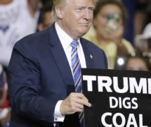 Donald Trump holds up a 
