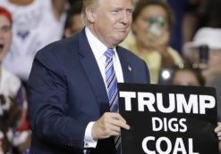 Donald Trump holds up a 