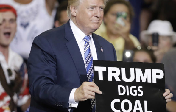 Donald Trump holds up a 