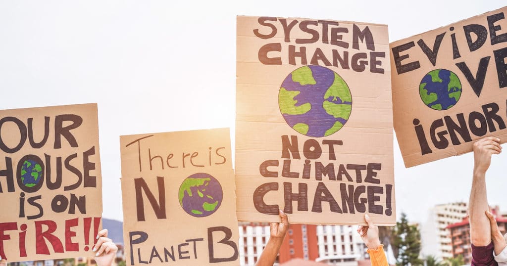 Group of demonstrators use the issue of climate change to protest the economic system. (Photo: AdobeStock)