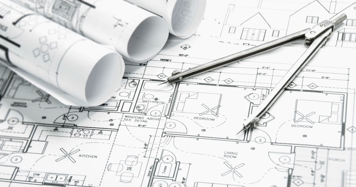 Construction planning drawings on the table and a compass. (Photo: AdobeStock)