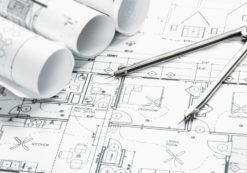 Construction planning drawings on the table and a compass. (Photo: AdobeStock)