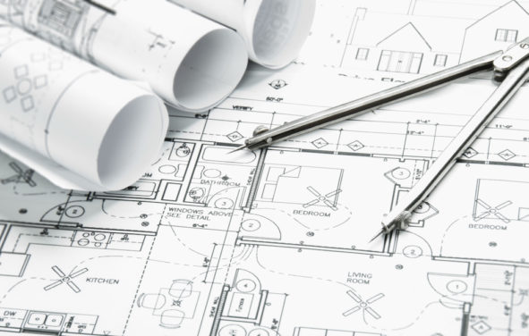 Construction planning drawings on the table and a compass. (Photo: AdobeStock)