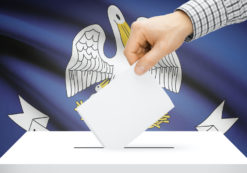 Voting, elections and state polls concept: Ballot box with state flag in the background - Louisiana. (Photo: AdobeStock)