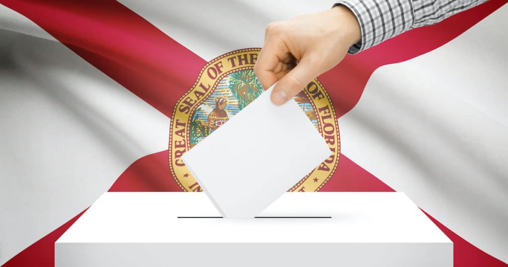 Voting, elections and state polls concept: Ballot box with state flag in the background - Florida. (Photo: AdobeStock)