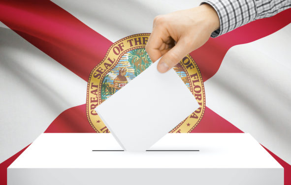 Voting, elections and state polls concept: Ballot box with state flag in the background - Florida. (Photo: AdobeStock)
