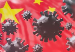 China coronavirus cells to illustrate epidemic pandemic flu virus infection, with a Chinese flag background. (Photo: AdobeStock)