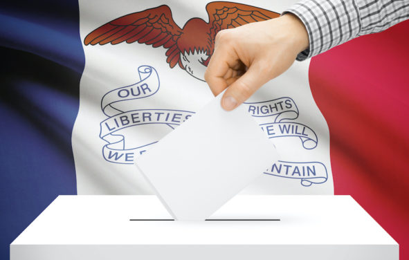 Voting, elections and state polls concept: Ballot box with state flag in the background - Iowa. (Photo: AdobeStock)