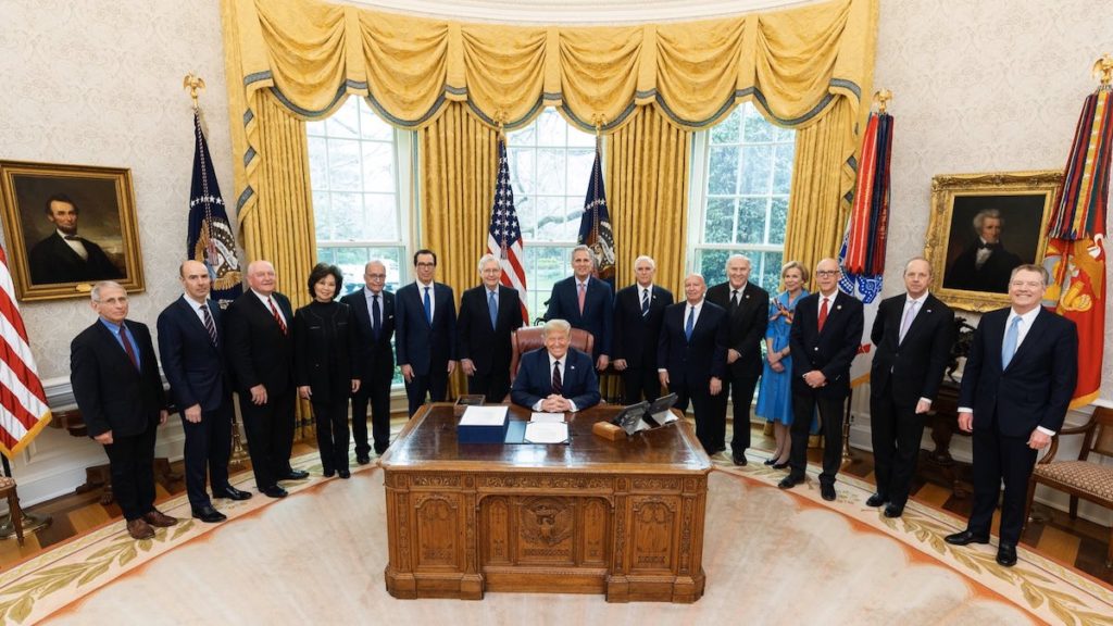 President Donald J. Trump, members of the U.S. Congress, Cabinet and the Coronavirus Task Force pose for the signing ceremony of the CARES Act on March 27, 2020. (Photo: White House)