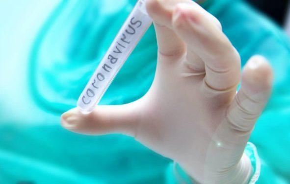 Researcher holds test tube with coronavirus virus (COVID-19), analysis and medicine to fight the epidemic. (Photo: AdobeStock)