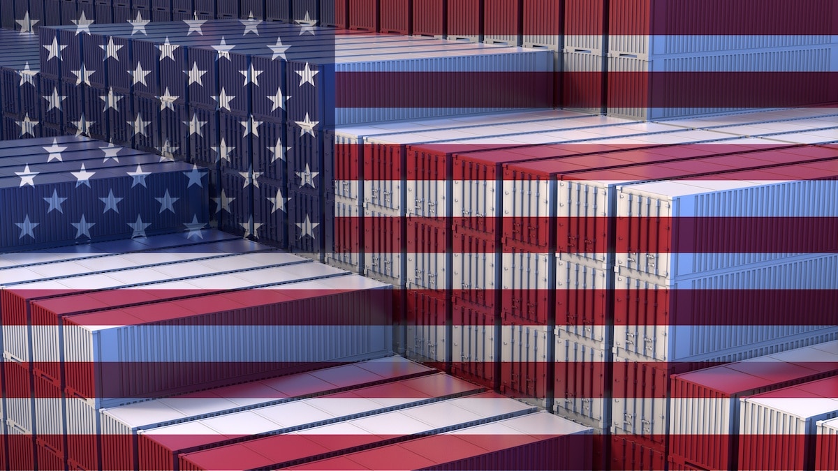 U.S. Economy. Import export business. Stacked cargo containers. Flag of the United States. 3D rendering. (Photo: AdobeStock)