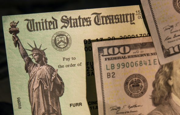 United States Treasury check surrounded by U.S. currency to illustrate a stimulus package or income tax refunds from the Internal Revenue Service (IRS). (Photo: AdobeStock)