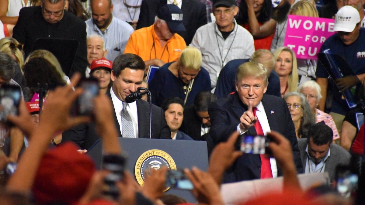 President Donald Trump, flagged by Ron DeSantis, touts "promises kept" A support tries to capture a photo/video of President Donald Trump President Donald Trump jokes with the crowd President Donald Trump touts record low unemployment for minorities during a rally in Tampa, Florida on Tuesday, July 31, 2018. (Photo: Laura Baris/People's Pundit Daily)