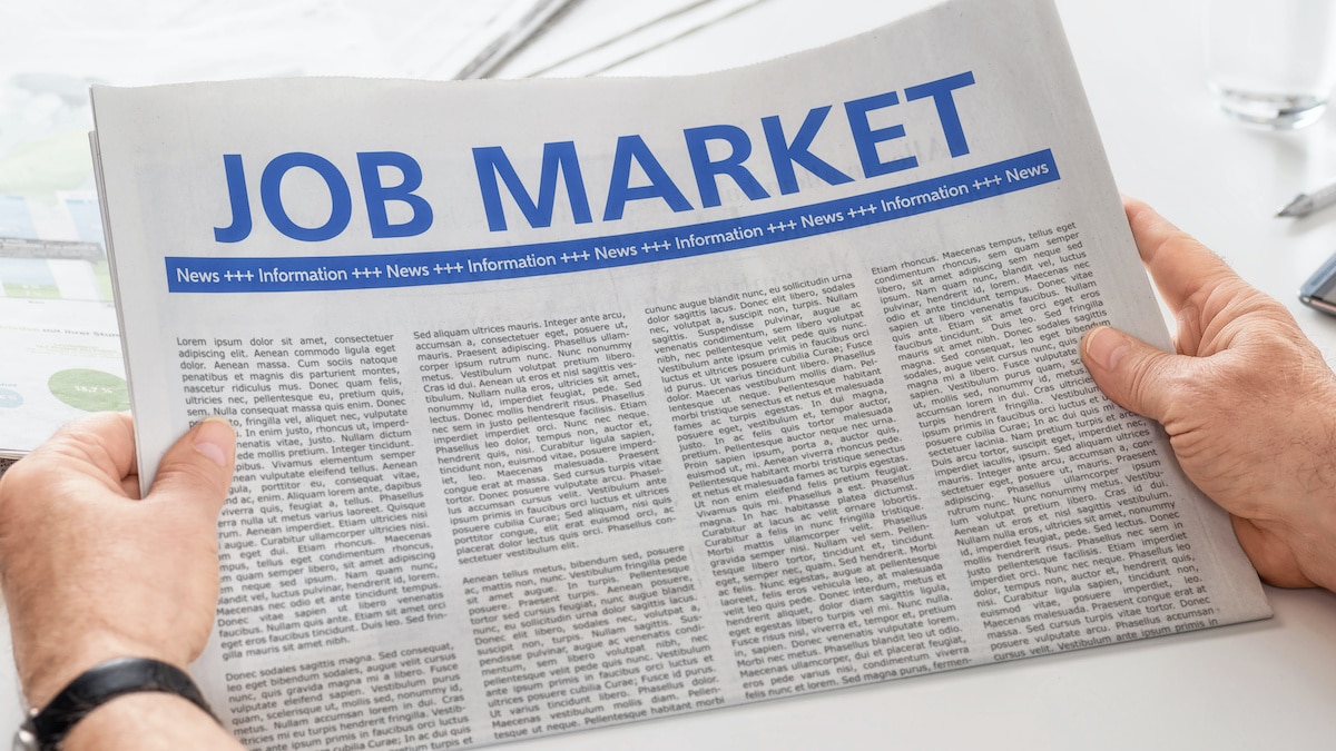 Man reading newspaper with the headline Job Market. (Photo: AdobeStock)