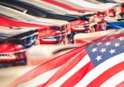 Buying American Made Cars. Supporting the American auto industry and economy photomontage with automobiles and the American Flag. (Photo: AdobeStock)