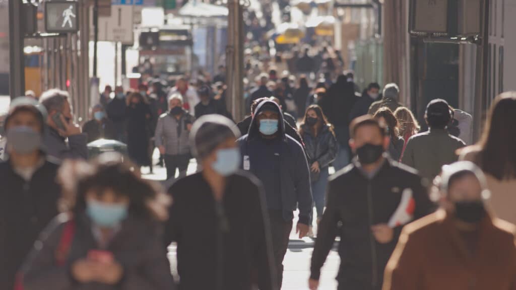Crowd of people walking the city streets while wearing masks during the coronavirus (Covid-19) pandemic. (Photo: AdobeStock)